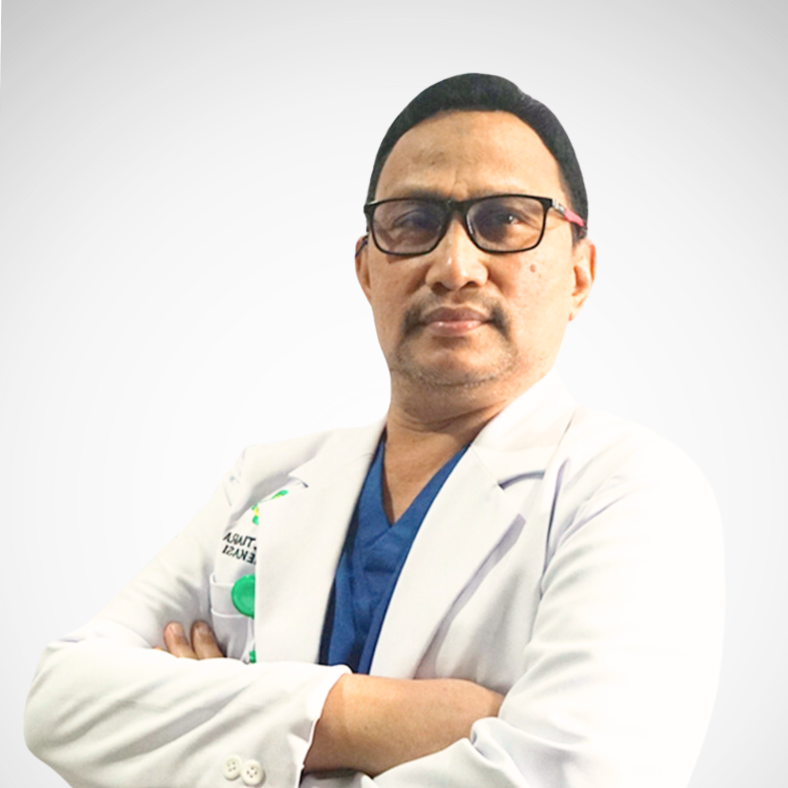 Person in medical attire, confident pose.